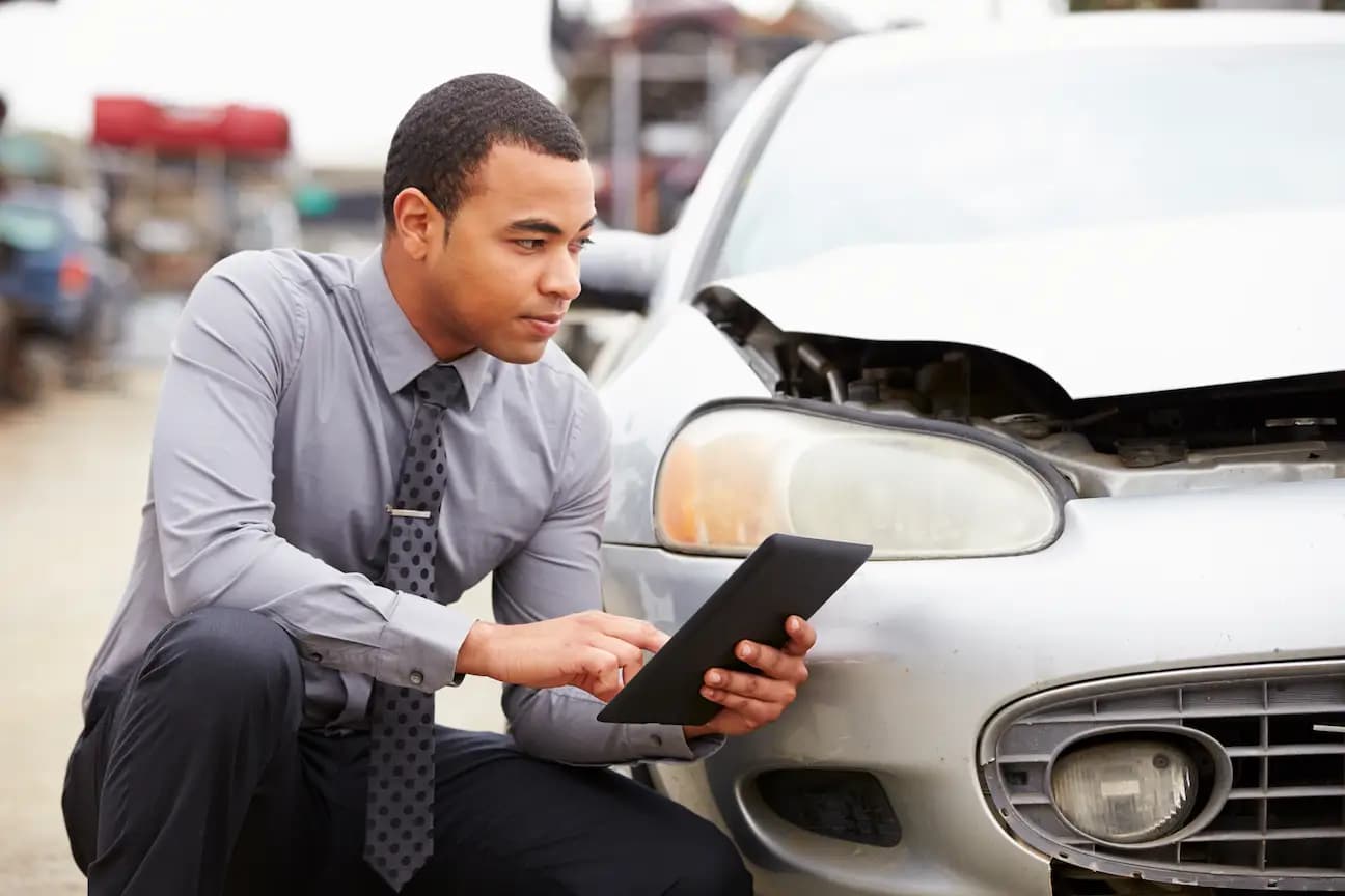 A man inspection a car